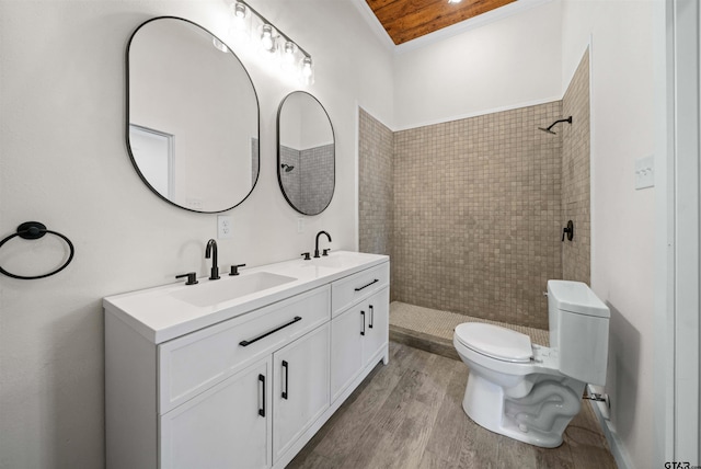 1314 N Queen St, Palestine, TX 75803 - bathroom with a sink, double vanity, toilet, tiled shower, and wood finished floors