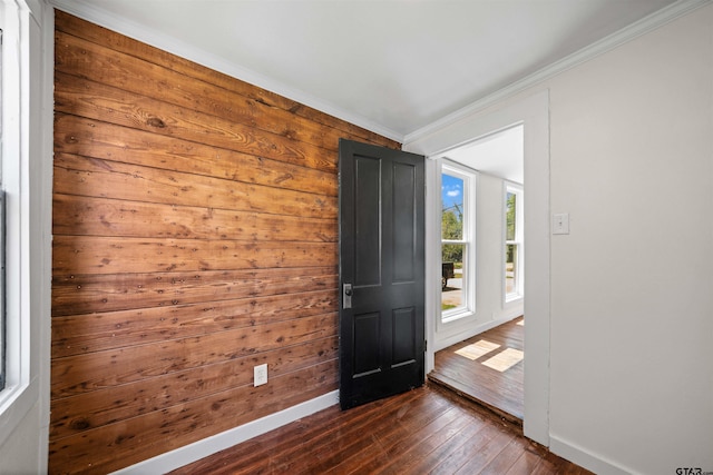 1314 N Queen St, Palestine, TX 75803 - entrance foyer with baseboards, wooden walls, dark wood-style flooring, and crown molding