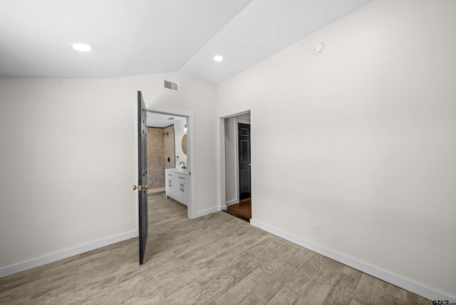 1314 N Queen St, Palestine, TX 75803 - unfurnished bedroom featuring vaulted ceiling, baseboards, visible vents, recessed lighting, and wood finished floors