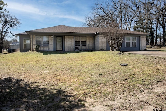 view of front of property with a front yard and brick siding