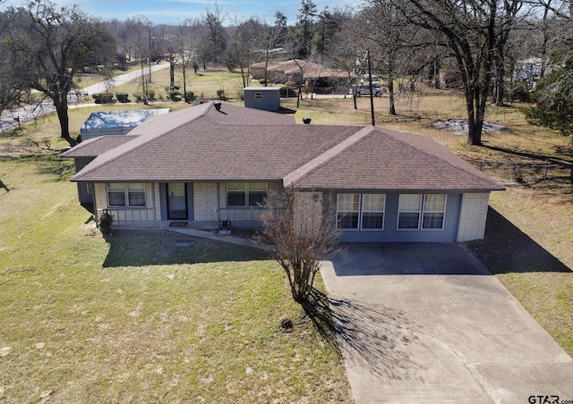 single story home featuring brick siding, driveway, a front lawn, and roof with shingles