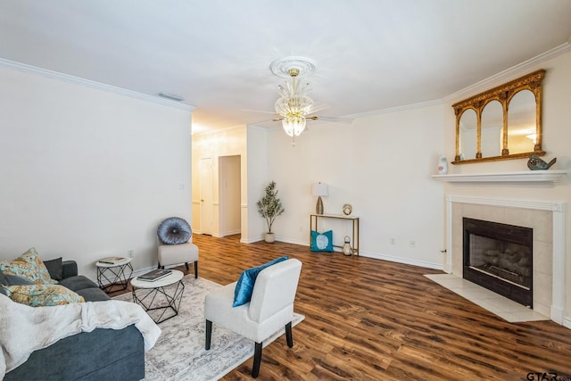 5401 Hollytree Dr, Tyler, TX 75703 - living room with crown molding, wood finished floors, a ceiling fan, a tile fireplace, and baseboards