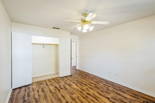 5401 Hollytree Dr, Tyler, TX 75703 - unfurnished bedroom with wood finished floors, a closet, baseboards, and ceiling fan