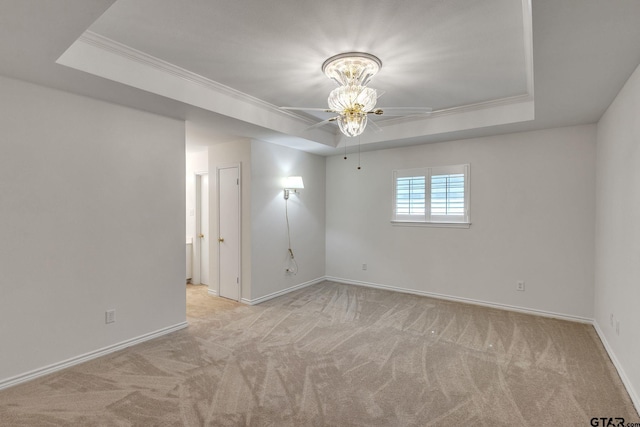 5401 Hollytree Dr, Tyler, TX 75703 - spare room featuring a raised ceiling, ceiling fan, carpet, and crown molding