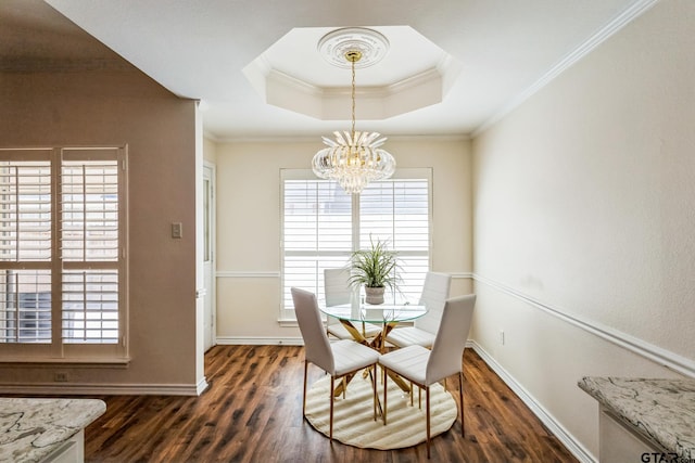 5401 Hollytree Dr, Tyler, TX 75703 - dining area with ornamental molding, a chandelier, a tray ceiling, dark wood-style flooring, and plenty of natural light