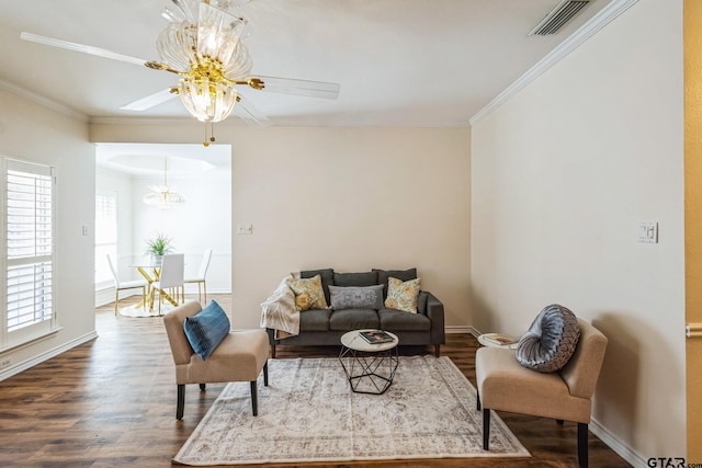 5401 Hollytree Dr, Tyler, TX 75703 - living area featuring dark wood-type flooring, ornamental molding, baseboards, a chandelier, and ceiling fan