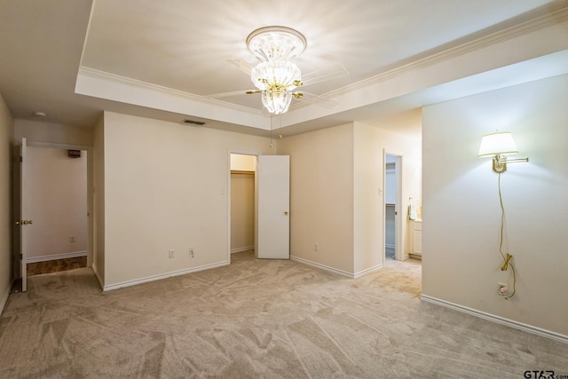 5401 Hollytree Dr, Tyler, TX 75703 - unfurnished bedroom featuring a raised ceiling, light carpet, ornamental molding, baseboards, and connected bathroom