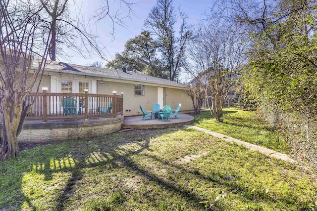 back of house featuring a yard, a deck, and a patio