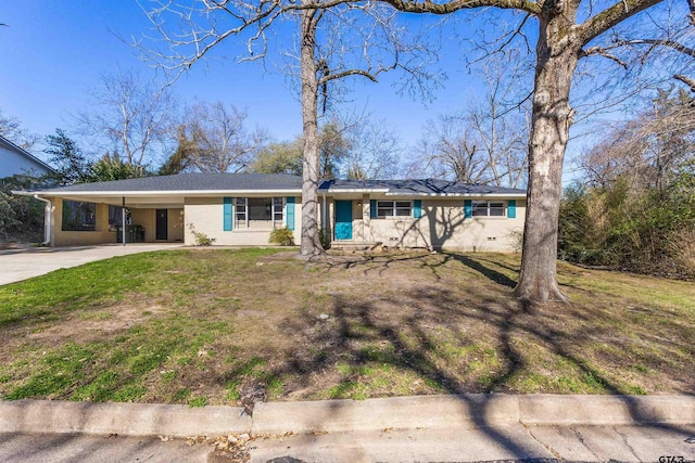 ranch-style home with a front yard and a carport