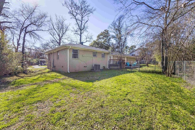 back of house with a yard and central AC