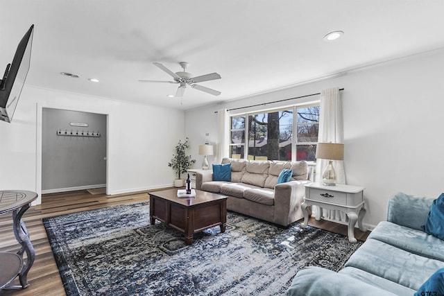 living room with ceiling fan, dark hardwood / wood-style floors, and ornamental molding