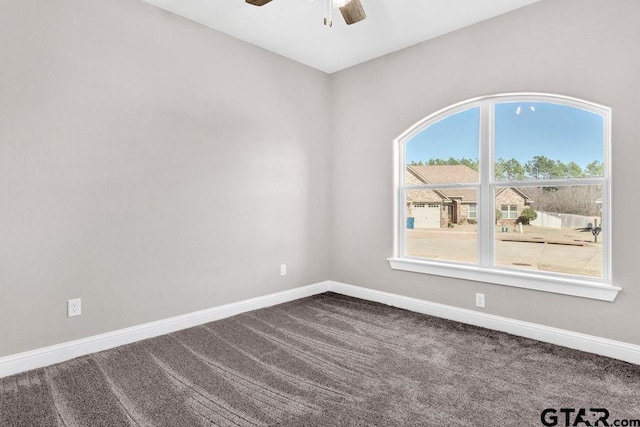 spare room with baseboards, carpet floors, and ceiling fan