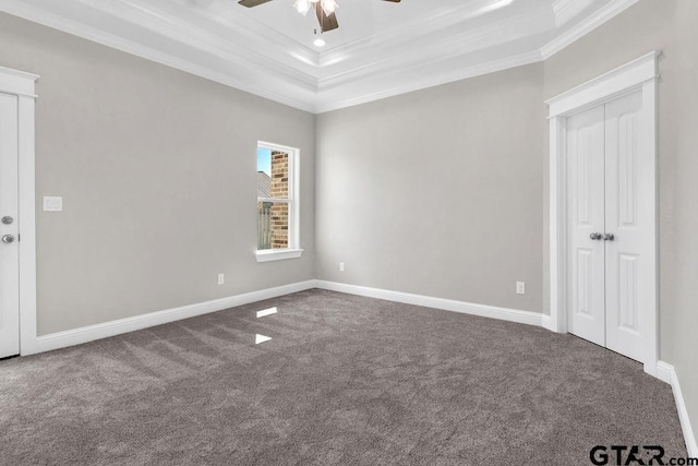 carpeted spare room with crown molding, baseboards, recessed lighting, a raised ceiling, and a ceiling fan