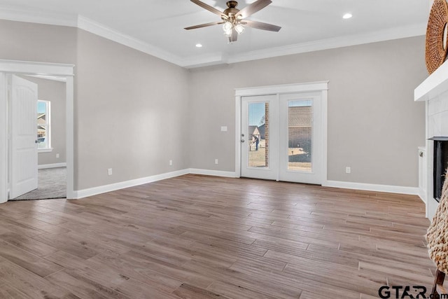 unfurnished living room featuring ornamental molding, a fireplace, and wood finished floors