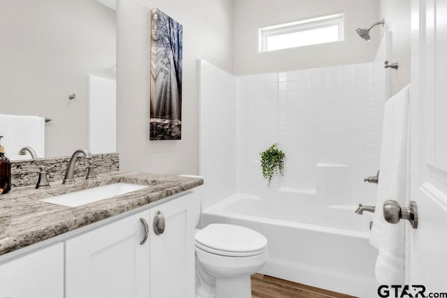 full bathroom with vanity,  shower combination, toilet, and wood finished floors