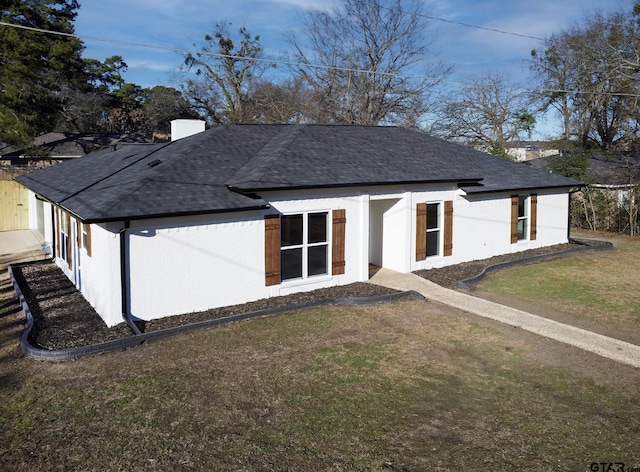 back of house featuring a yard