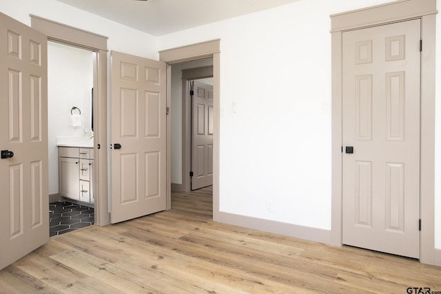 interior space featuring light hardwood / wood-style floors and ensuite bathroom