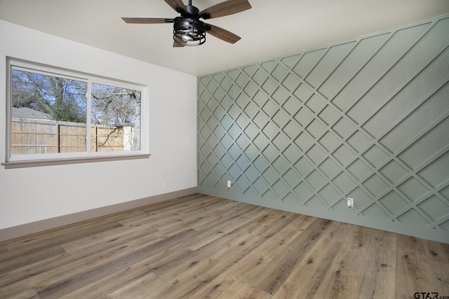 empty room featuring ceiling fan and light hardwood / wood-style flooring