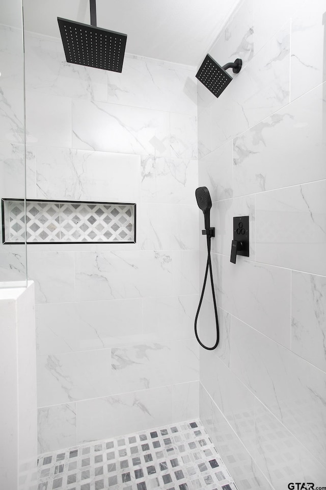 bathroom with a tile shower