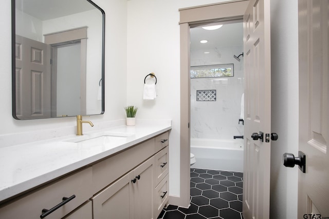 full bathroom with vanity, tiled shower / bath, tile patterned flooring, and toilet