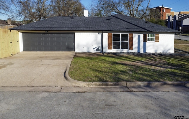 ranch-style house with a garage and a front yard