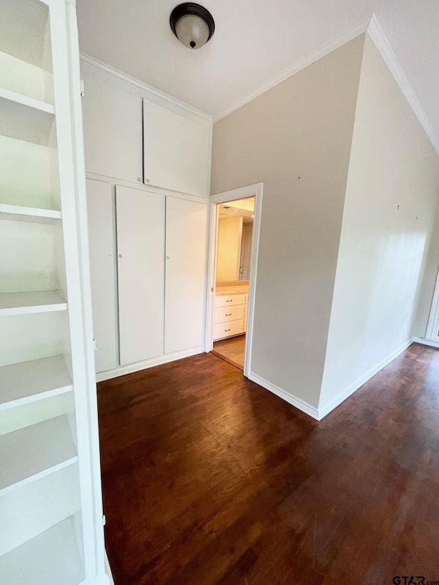 1106 E Redbud, Crockett, TX 75835 - hallway with crown molding, dark wood-style flooring, and built in features