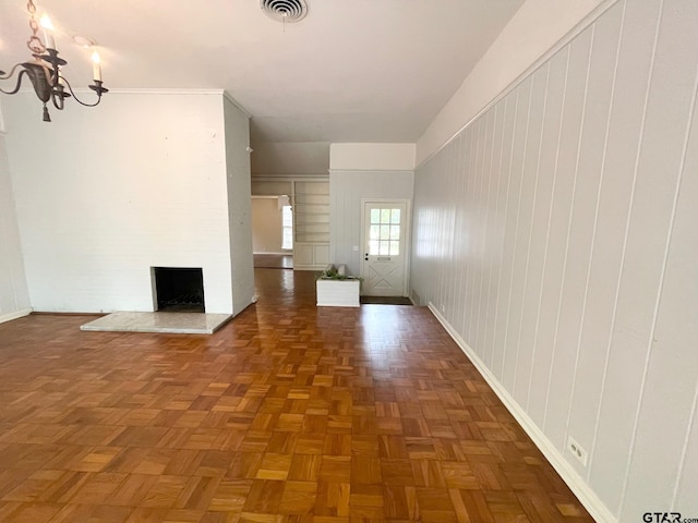 1106 E Redbud, Crockett, TX 75835 - unfurnished living room featuring a chandelier and a fireplace with raised hearth