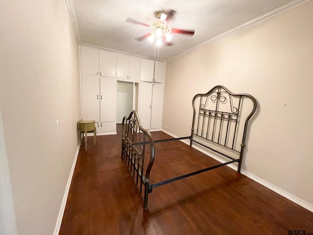 1106 E Redbud, Crockett, TX 75835 - bedroom featuring dark wood-style floors, ornamental molding, a closet, and a ceiling fan