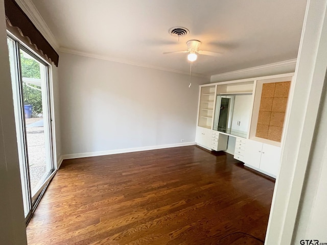 1106 E Redbud, Crockett, TX 75835 - unfurnished bedroom with built in study area, dark wood-style floors, ornamental molding, and ceiling fan