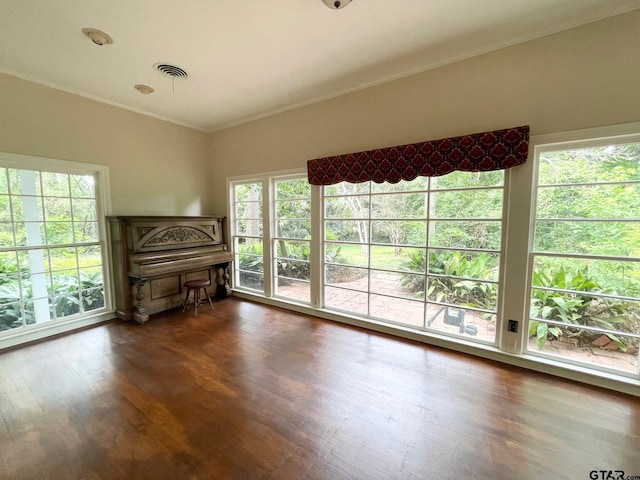 1106 E Redbud, Crockett, TX 75835 - unfurnished living room with wood finished floors and crown molding