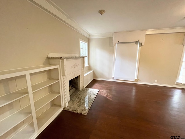 1106 E Redbud, Crockett, TX 75835 - unfurnished living room with crown molding, wood finished floors, and a fireplace