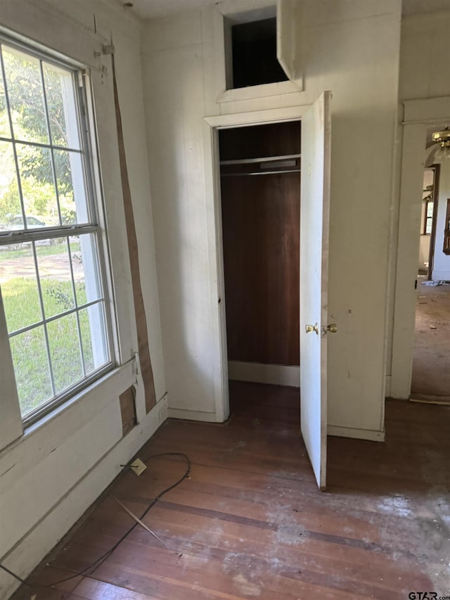 107 Acorn Dr, Marshall, TX 75670 - unfurnished bedroom with hardwood / wood-style flooring, multiple windows, and a closet