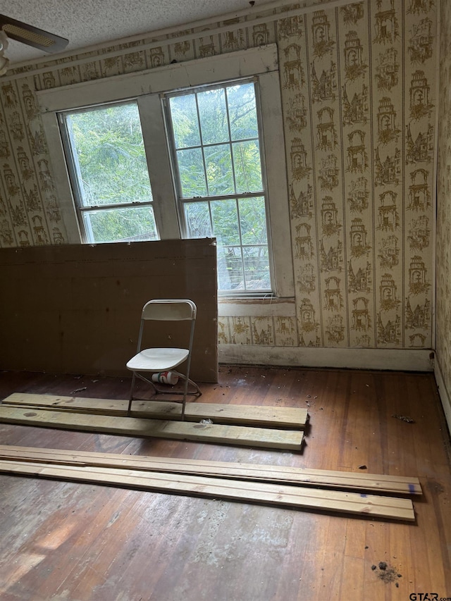 107 Acorn Dr, Marshall, TX 75670 - sitting room with wood-type flooring, wallpapered walls, and healthy amount of natural light