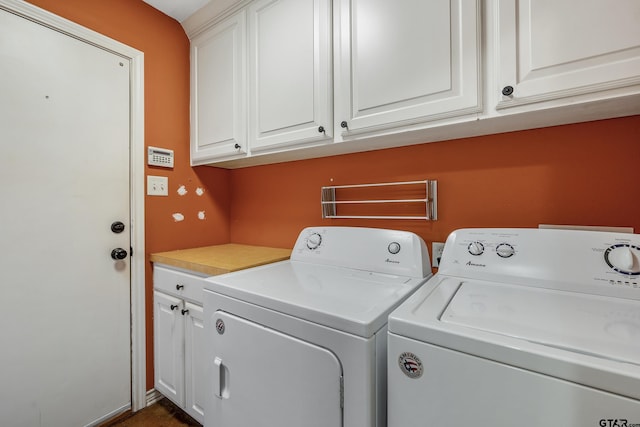 washroom featuring cabinets and washing machine and clothes dryer