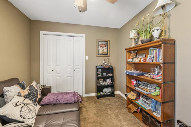 living area featuring ceiling fan and carpet floors