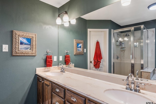 bathroom with a shower with door and vanity