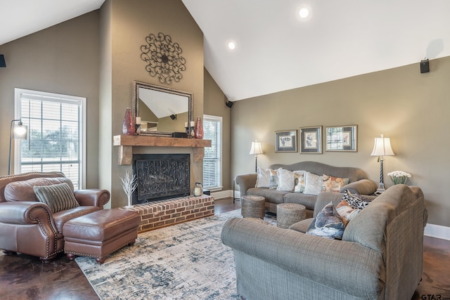 living room with a fireplace and high vaulted ceiling