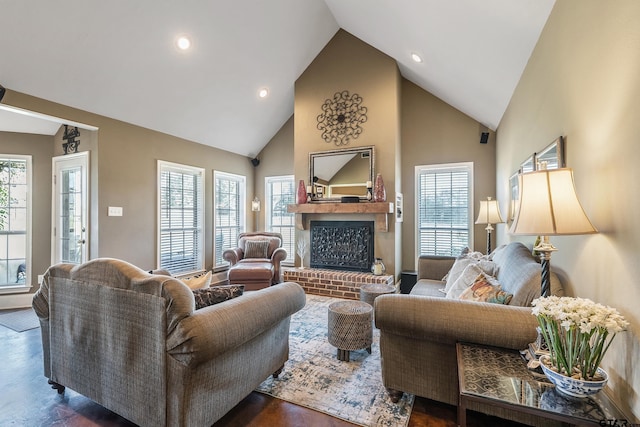 living room with high vaulted ceiling, dark hardwood / wood-style flooring, a fireplace, and a wealth of natural light