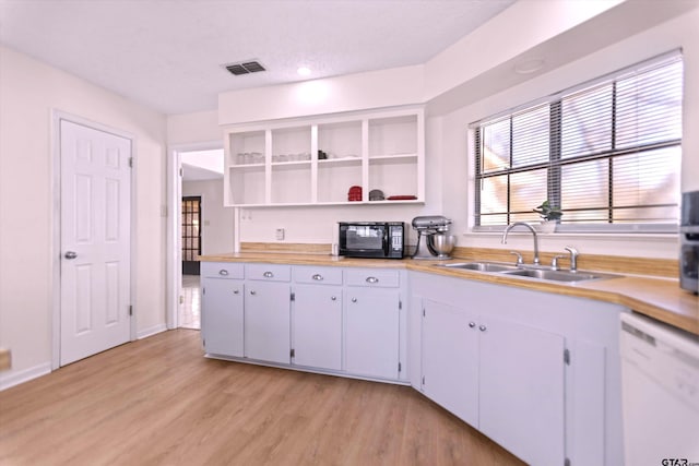 kitchen with visible vents, a sink, black microwave, dishwasher, and open shelves