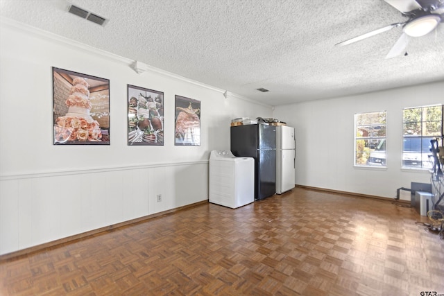 unfurnished room featuring washer / dryer, crown molding, visible vents, and a textured ceiling