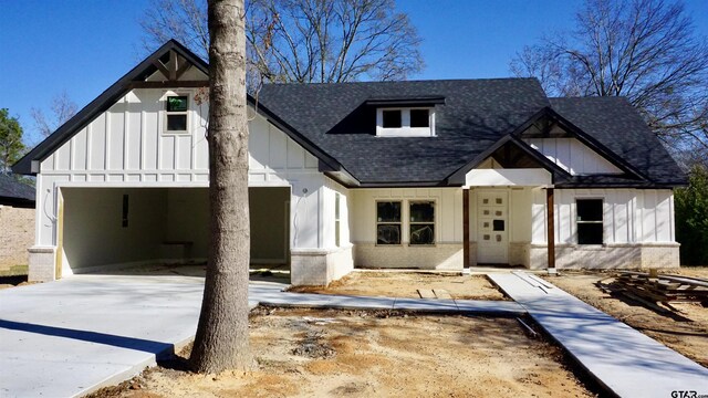 modern inspired farmhouse featuring a carport