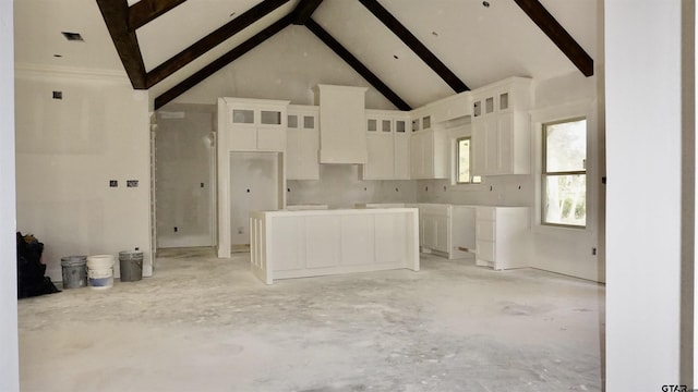 kitchen featuring white cabinets, beamed ceiling, and high vaulted ceiling