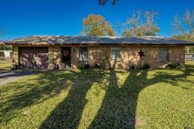 single story home featuring a front yard and a garage