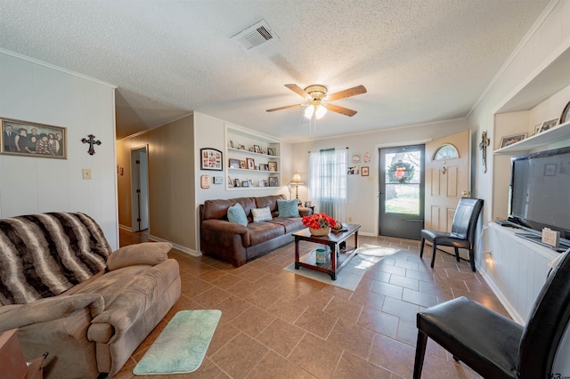 living room with built in shelves, ceiling fan, and a textured ceiling