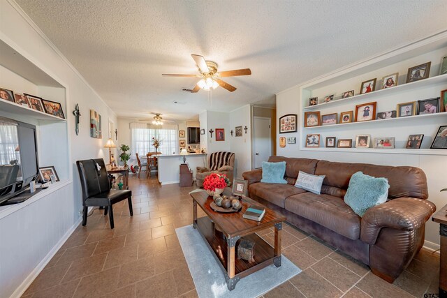 tiled living room featuring a textured ceiling and ceiling fan