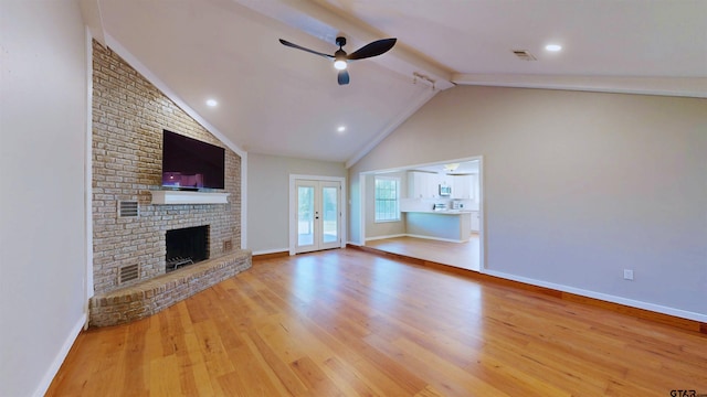 15269 County Road 1227, Flint, TX 75762 - unfurnished living room with beam ceiling, wood finished floors, a ceiling fan, french doors, and a fireplace