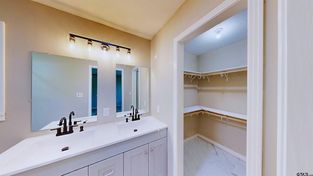 15269 County Road 1227, Flint, TX 75762 - full bathroom with double vanity, marble finish floors, and a walk in closet