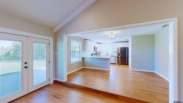 15269 County Road 1227, Flint, TX 75762 - kitchen with stainless steel appliances, french doors, light wood-type flooring, a peninsula, and vaulted ceiling