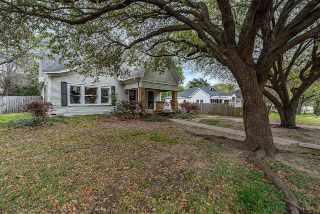exterior space with a porch and fence