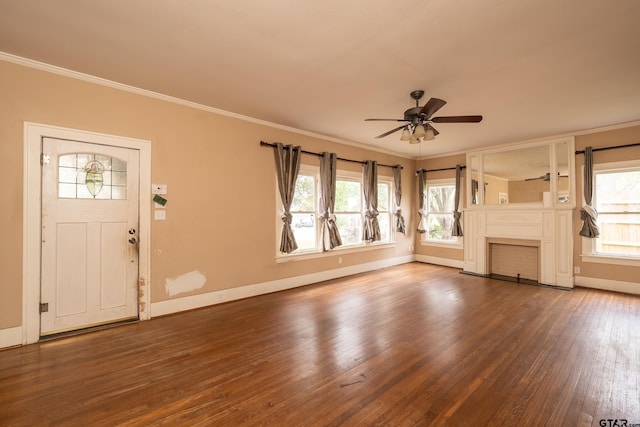 unfurnished living room with a wealth of natural light, wood finished floors, ornamental molding, and a ceiling fan